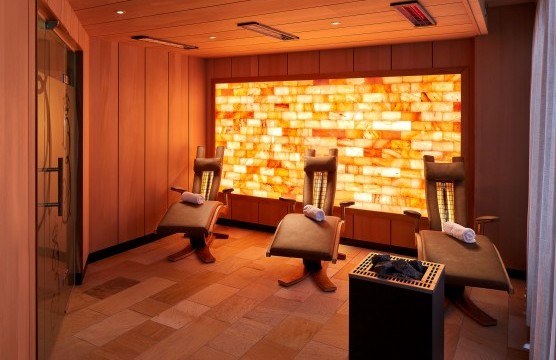 Infrared sauna with loungers and atmospheric lighting.